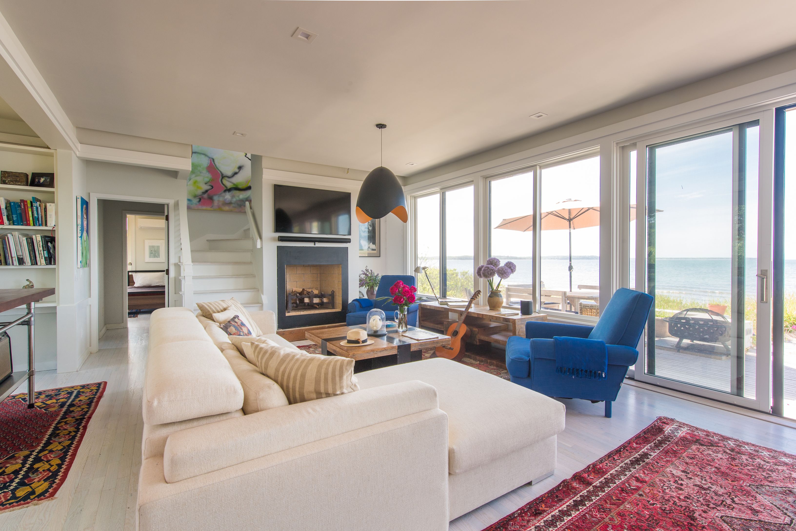 383 Cranberry Hole Road Amagansett, NY 11930 - Photo 16 of 32 a living room with furniture fireplace and flat screen tv