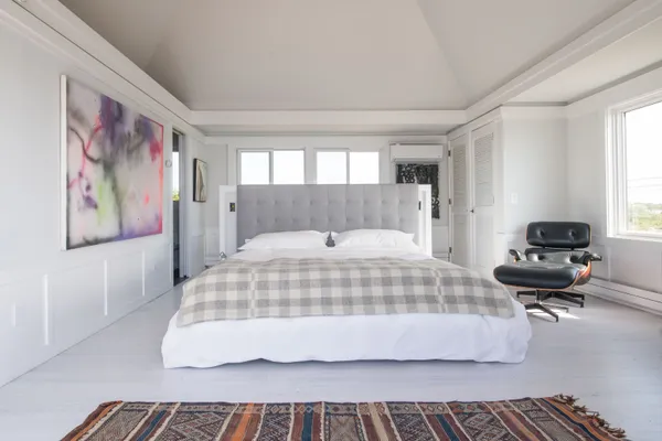 a bedroom with a bed and a chair