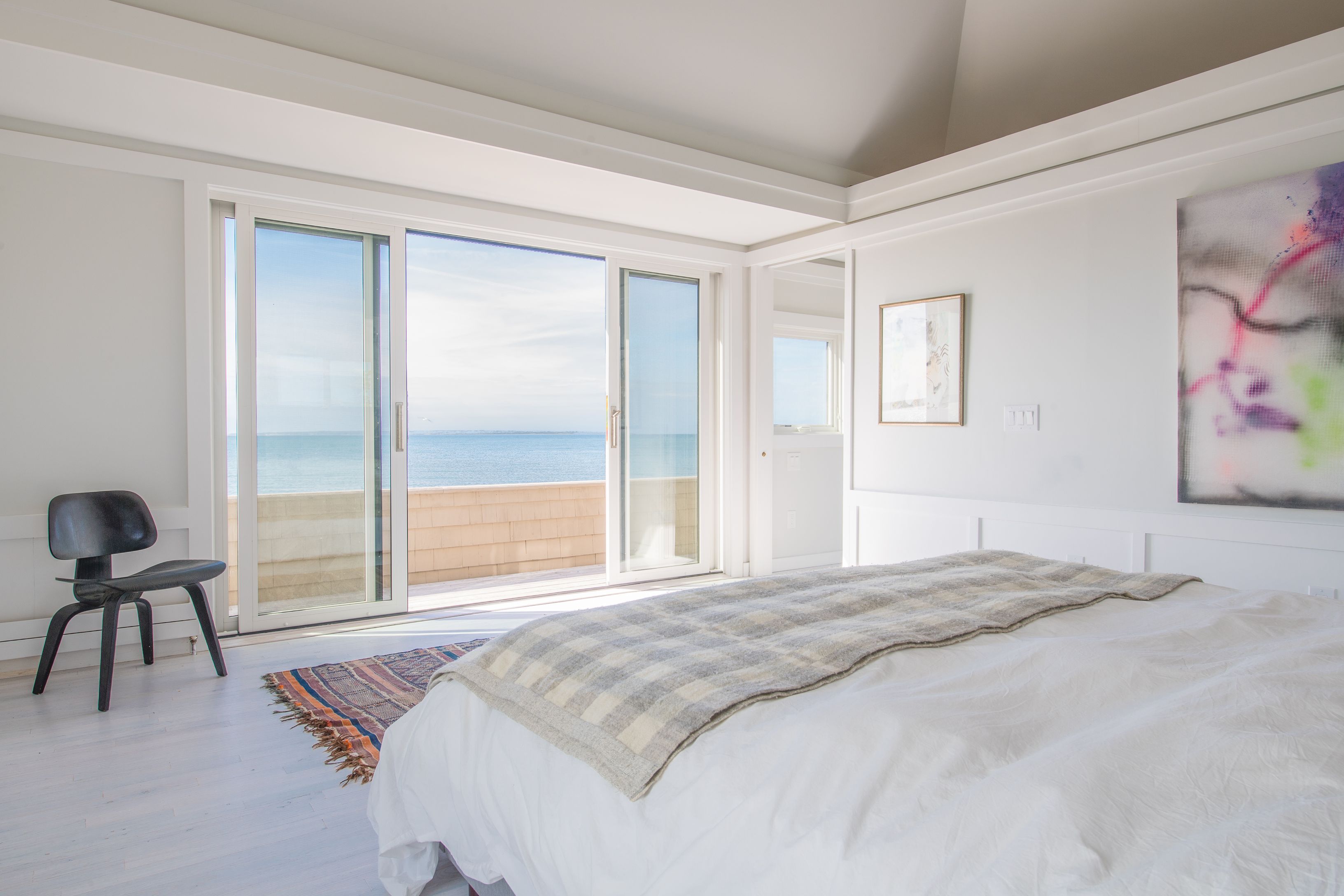 383 Cranberry Hole Road Amagansett, NY 11930 - Photo 18 of 32 a bedroom with a bed and a chair