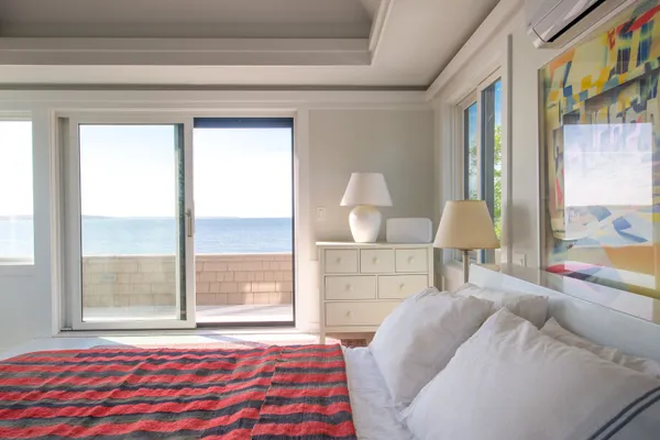 a bedroom with 2 bed and a window