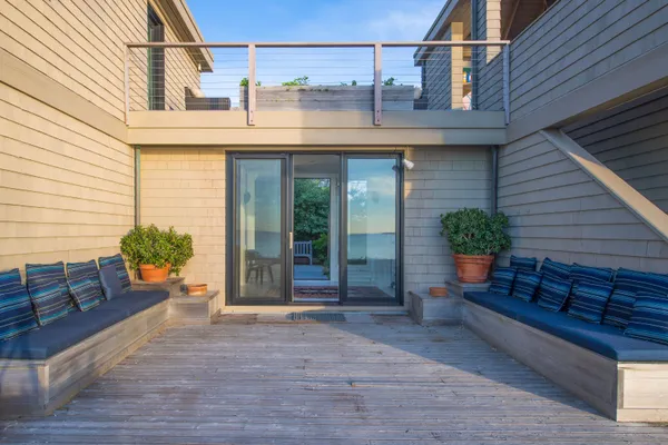 a view of a patio with couches chairs and potted plants