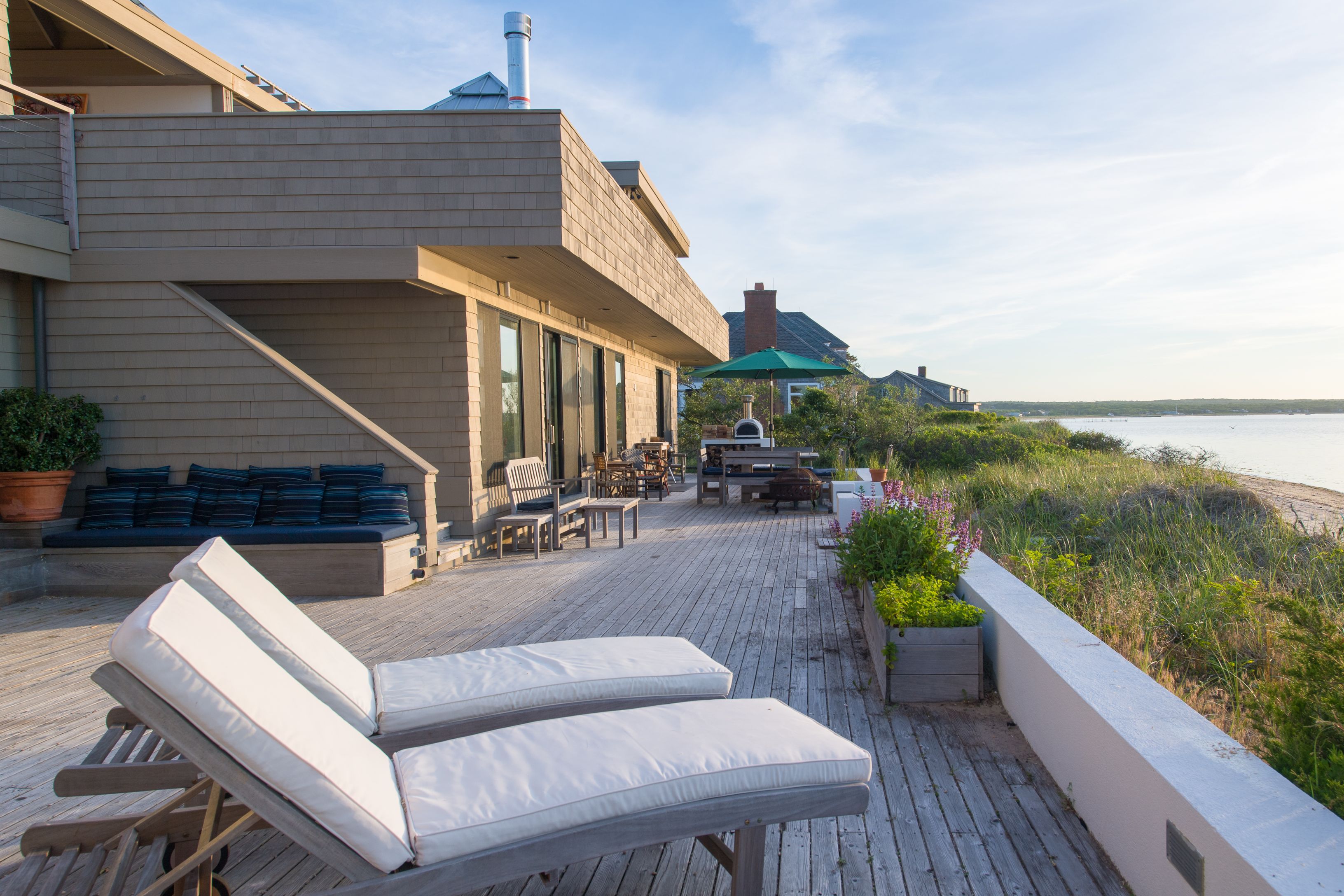 383 Cranberry Hole Road Amagansett, NY 11930 - Photo 30 of 32 a view of a patio with couches chairs and potted plants