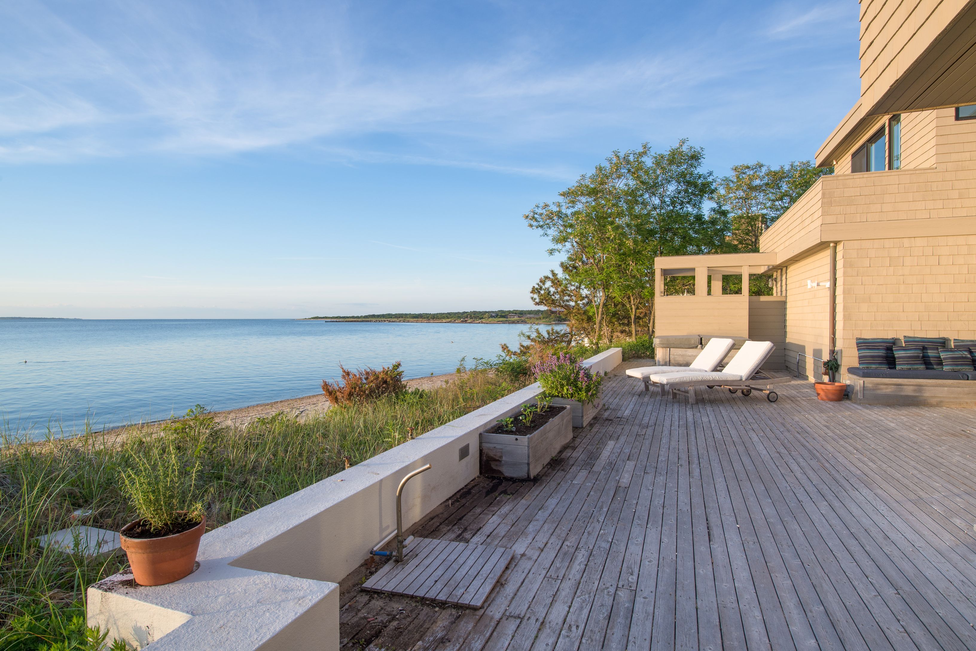383 Cranberry Hole Road Amagansett, NY 11930 - Photo 31 of 32 a balcony with wooden floor and outdoor seating