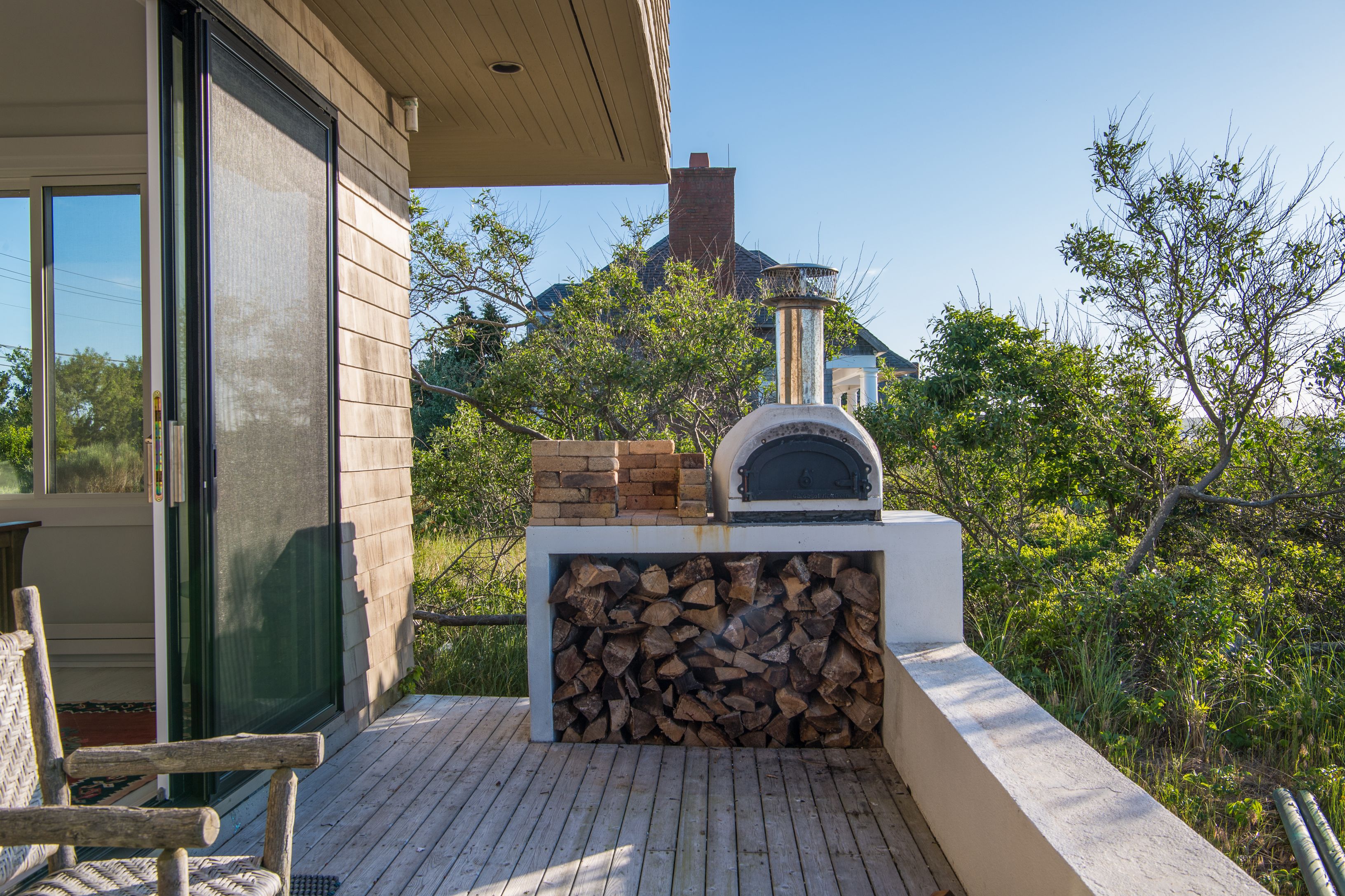 383 Cranberry Hole Road Amagansett, NY 11930 - Photo 5 of 32 a view of roof deck with table and chairs a barbeque with wooden floor and fence