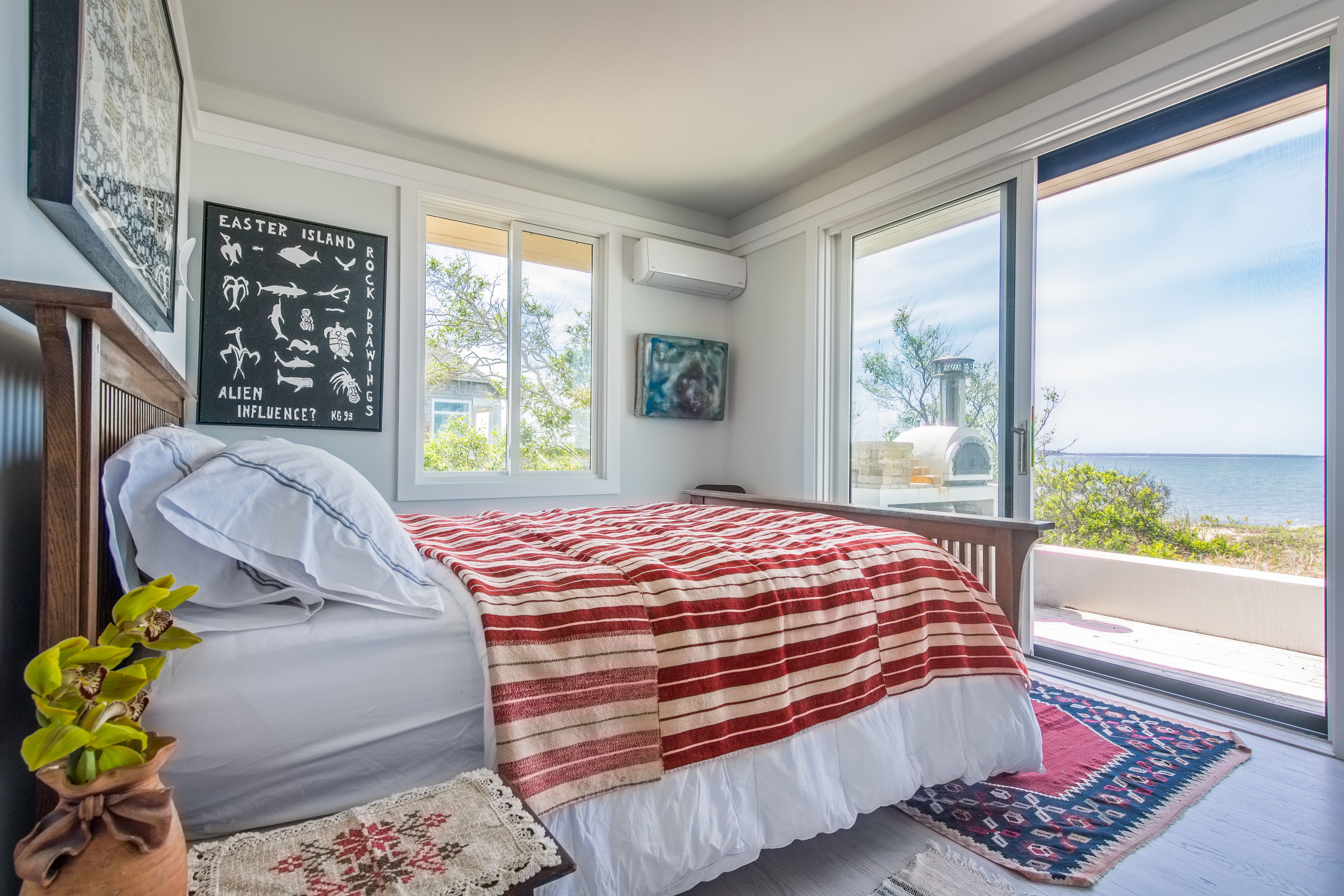 383 Cranberry Hole Road Amagansett, NY 11930 - Photo 10 of 32 a bedroom with a bed and a window