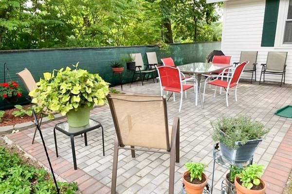 23 Grove Road Natick, MA 01760 - Photo 12 of 14 a patio with table and chairs and potted plants