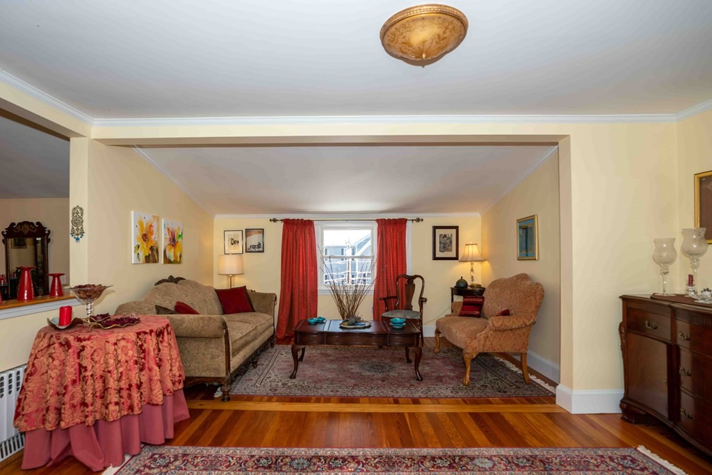 23 Grove Road Natick, MA 01760 - Photo 2 of 14 a living room with furniture and a fireplace