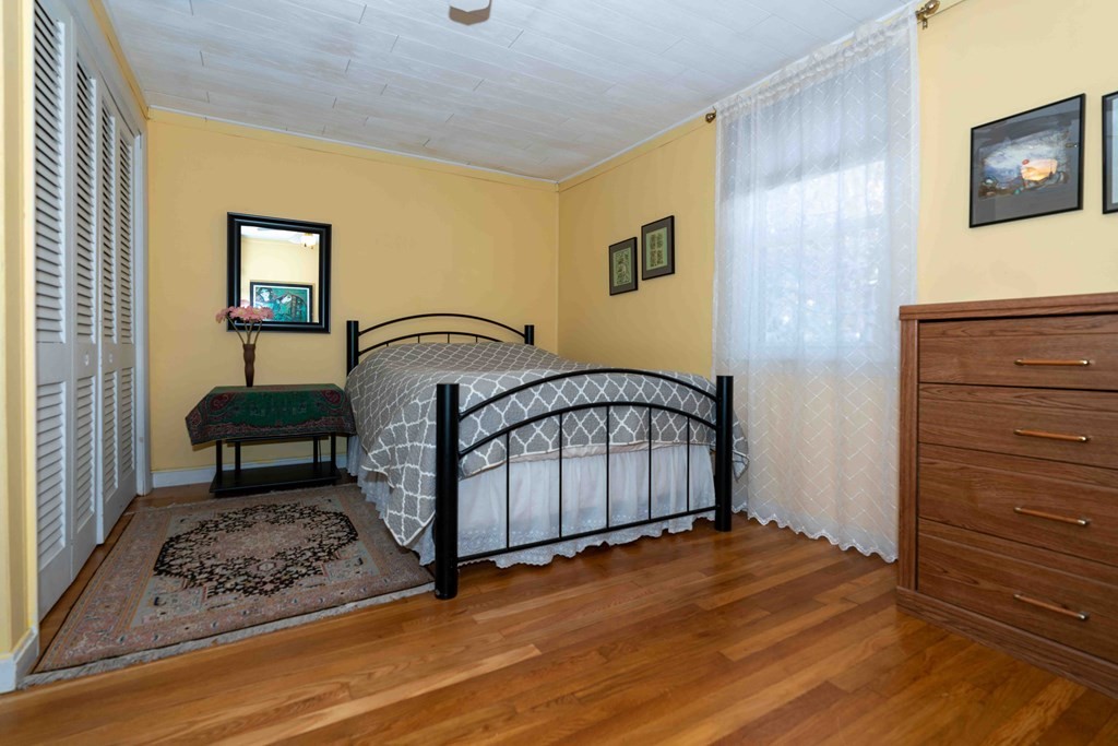 23 Grove Road Natick, MA 01760 - Photo 4 of 14 a living room with a bed furniture and a window