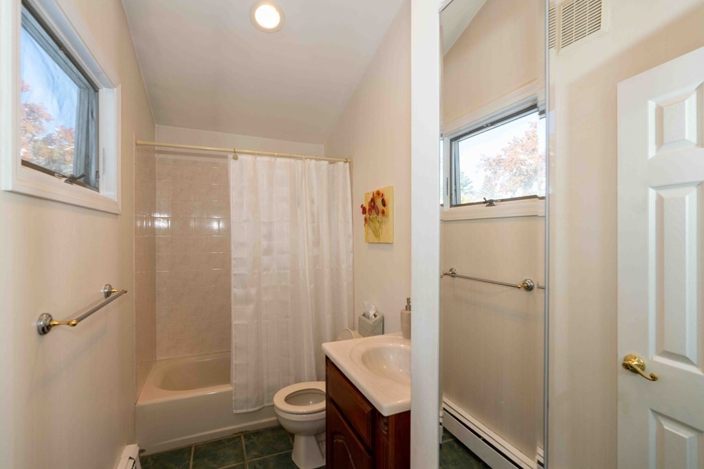 23 Grove Road Natick, MA 01760 - Photo 10 of 14 a bathroom with a sink a toilet and shower