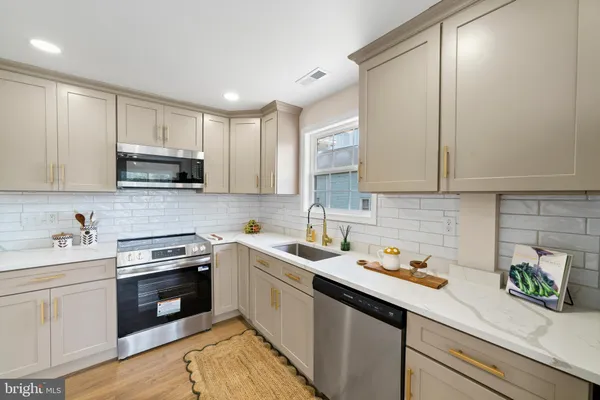 a kitchen with a sink stove and cabinets