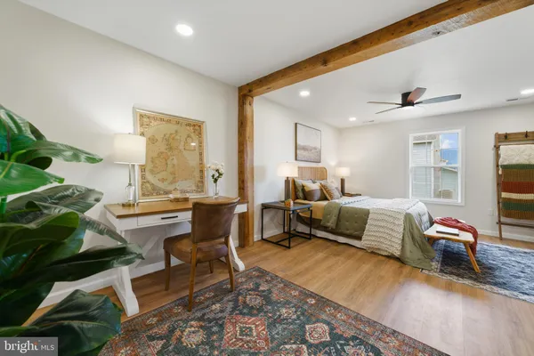 a bedroom with furniture and a window