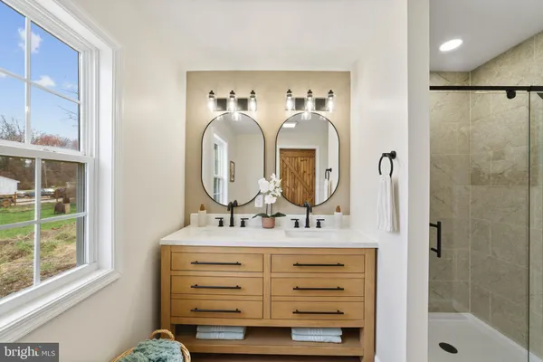 a bathroom with a mirror sink and vanity