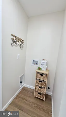 a view of a room with wooden floor