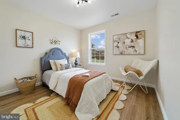 a bedroom with a bed and a chair