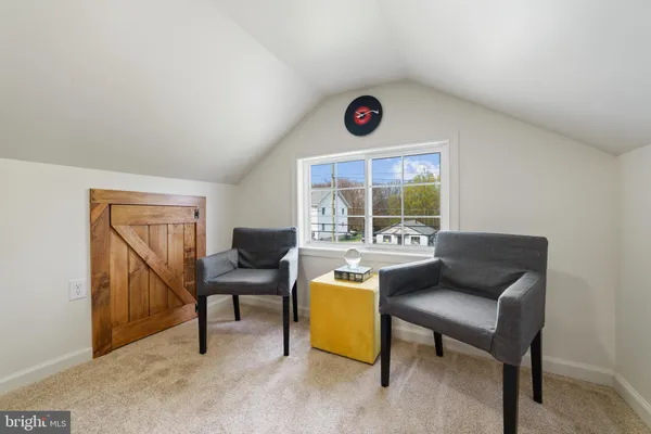 a bedroom with a bed window and couch