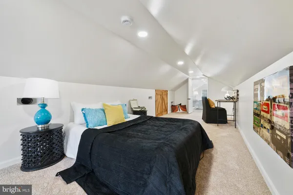 a bed room with a bed and a book shelf