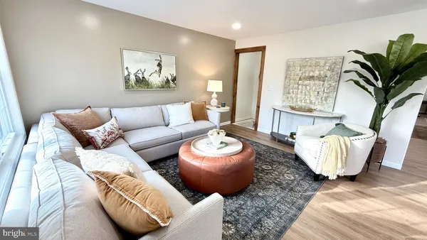 a living room with furniture and a painting