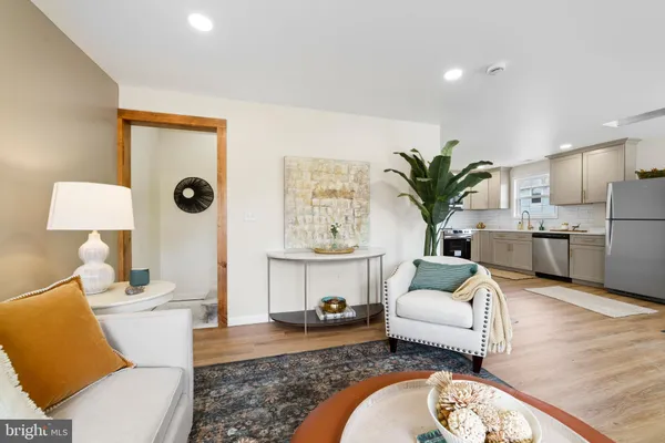 a living room with furniture a fireplace and a table