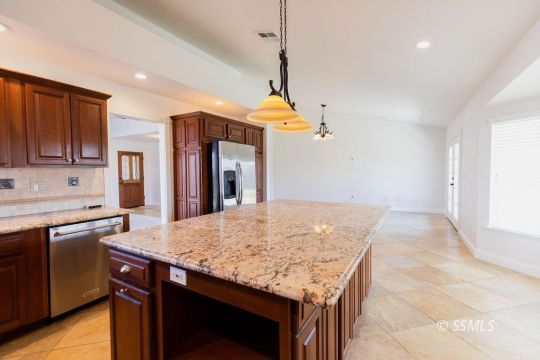 919 Beverly Court Ridgecrest, CA 93555 - Photo 15 of 29 a kitchen with granite countertop sink stove and refrigerator
