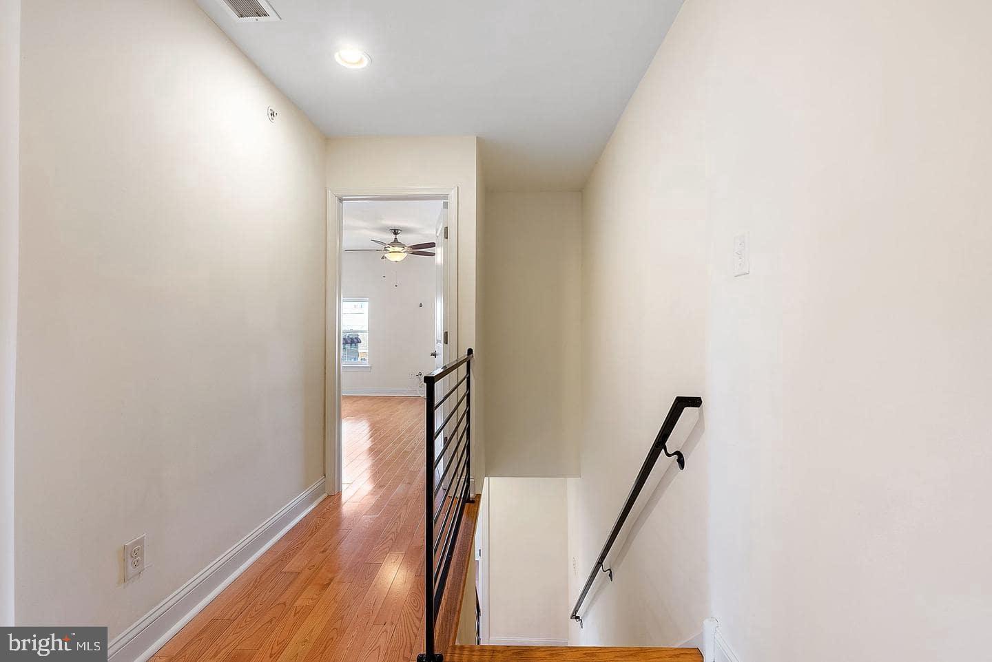 1347 South 20th Street, Unit A Philadelphia, PA 19146 - Photo 13 of 21 a view of a hallway with wooden floor and staircase