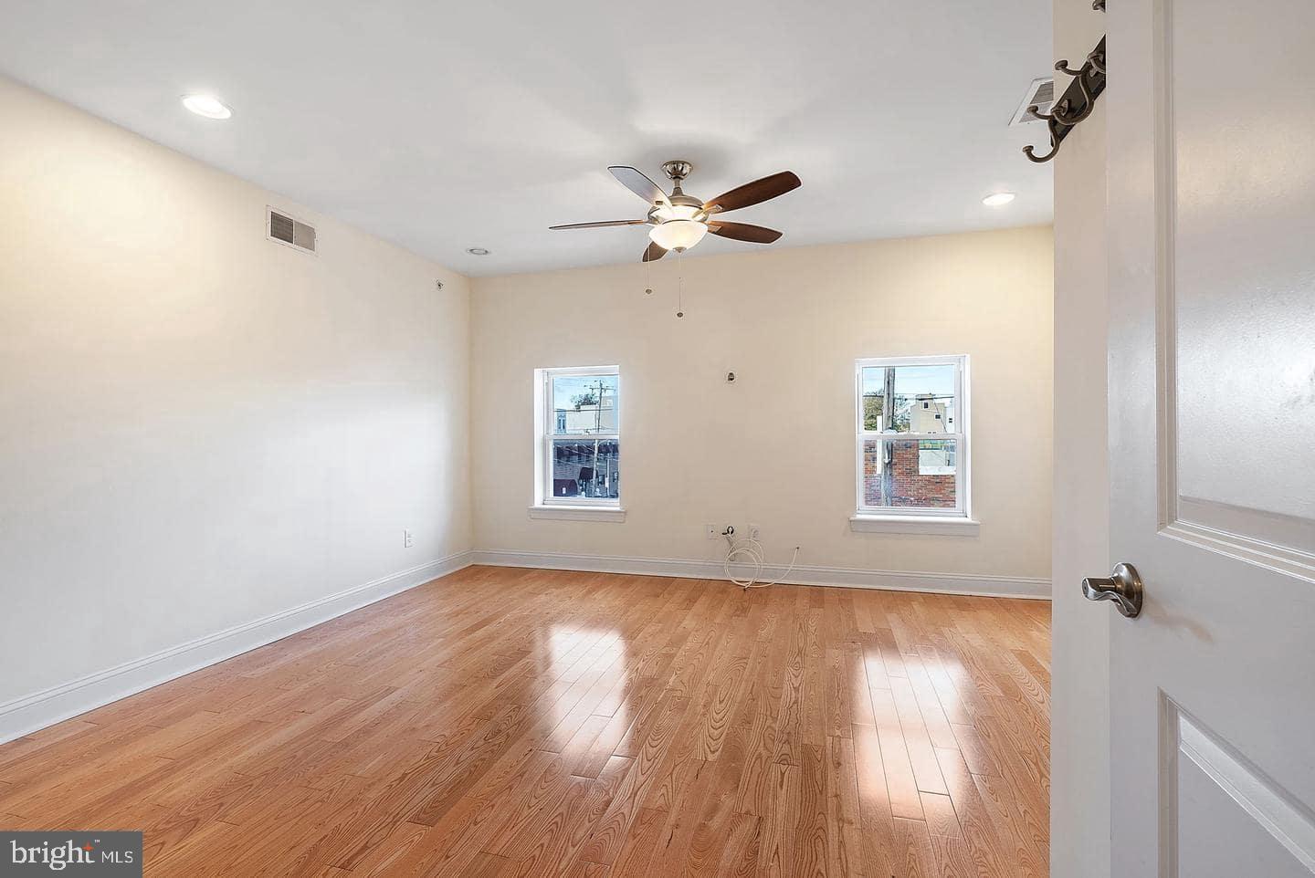 1347 South 20th Street, Unit A Philadelphia, PA 19146 - Photo 14 of 21 wooden floor in an empty room with a window