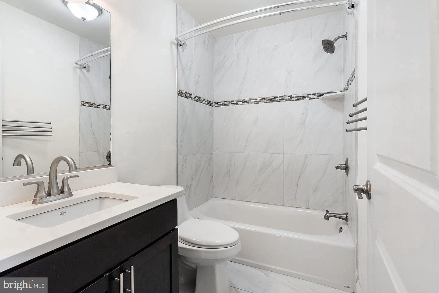 1347 South 20th Street, Unit A Philadelphia, PA 19146 - Photo 18 of 21 a bathroom with a sink a toilet and shower