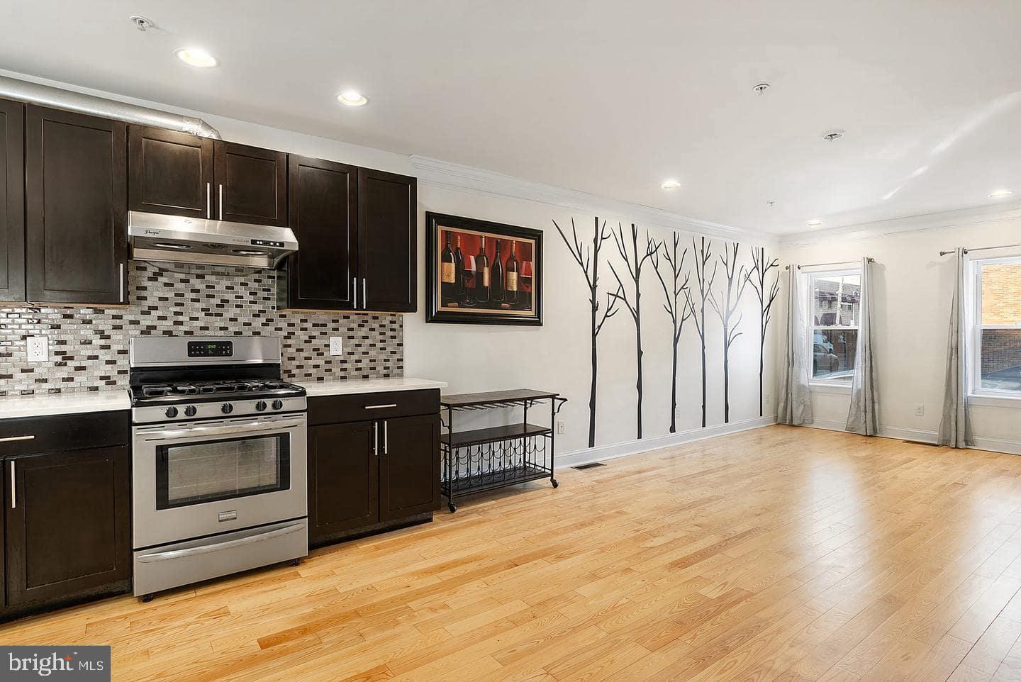 1347 South 20th Street, Unit A Philadelphia, PA 19146 - Photo 2 of 21 a kitchen with stainless steel appliances granite countertop a stove a sink and a refrigerator