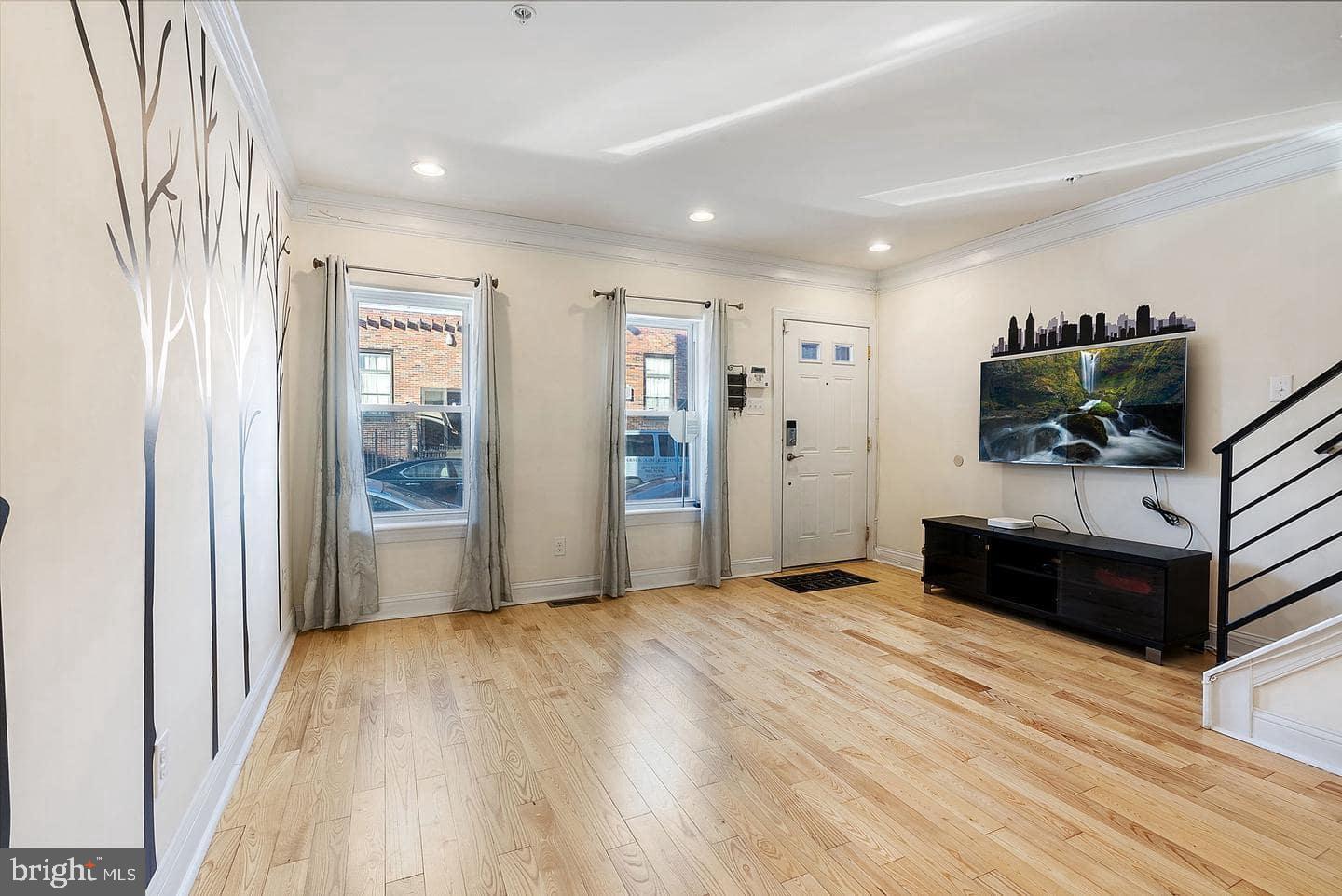 1347 South 20th Street, Unit A Philadelphia, PA 19146 - Photo 3 of 21 a view of a livingroom with wooden floor and a flat screen tv