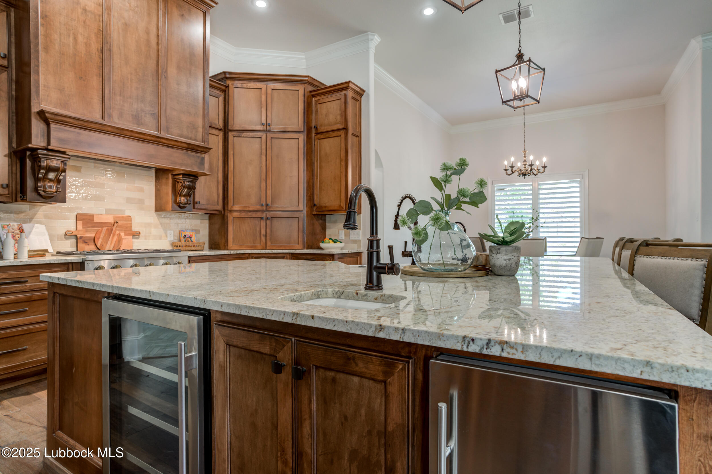 3913 106th Street Lubbock, TX 79423 - Photo 25 of 80 a kitchen with stainless steel appliances granite countertop a sink dishwasher a refrigerator white cabinets and wooden floor