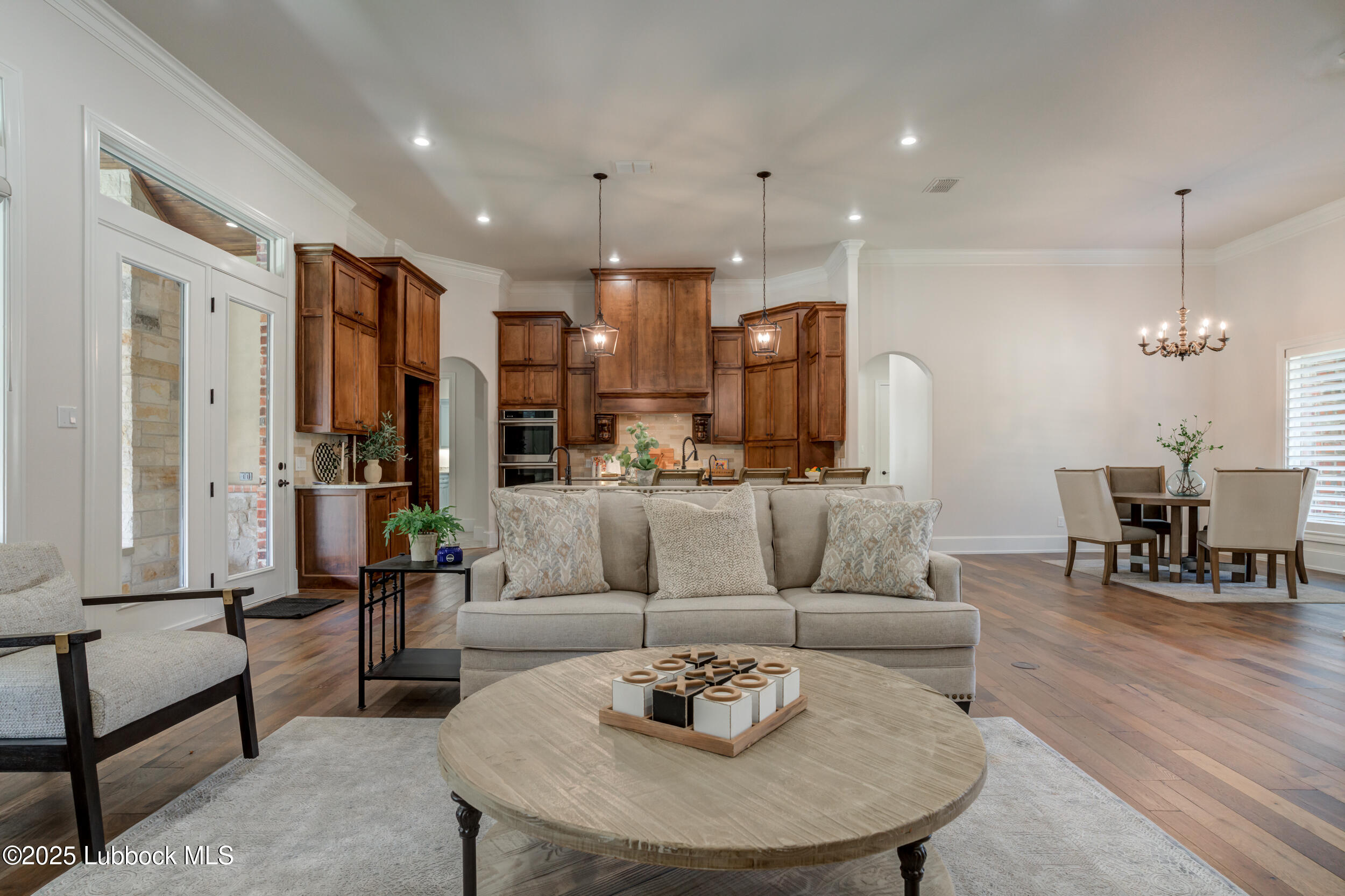 3913 106th Street Lubbock, TX 79423 - Photo 27 of 80 a living room with furniture kitchen view and a wooden floor