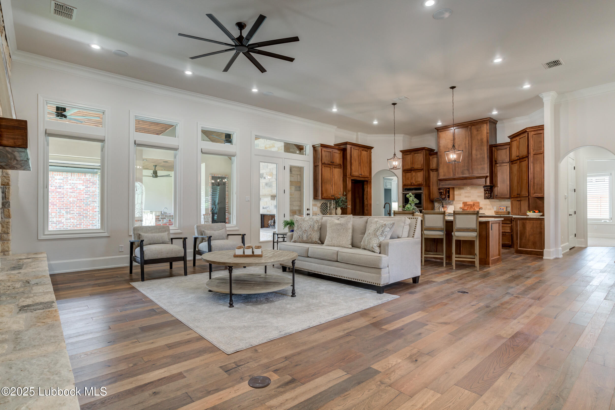 3913 106th Street Lubbock, TX 79423 - Photo 28 of 80 a living room with furniture kitchen view and a wooden floor