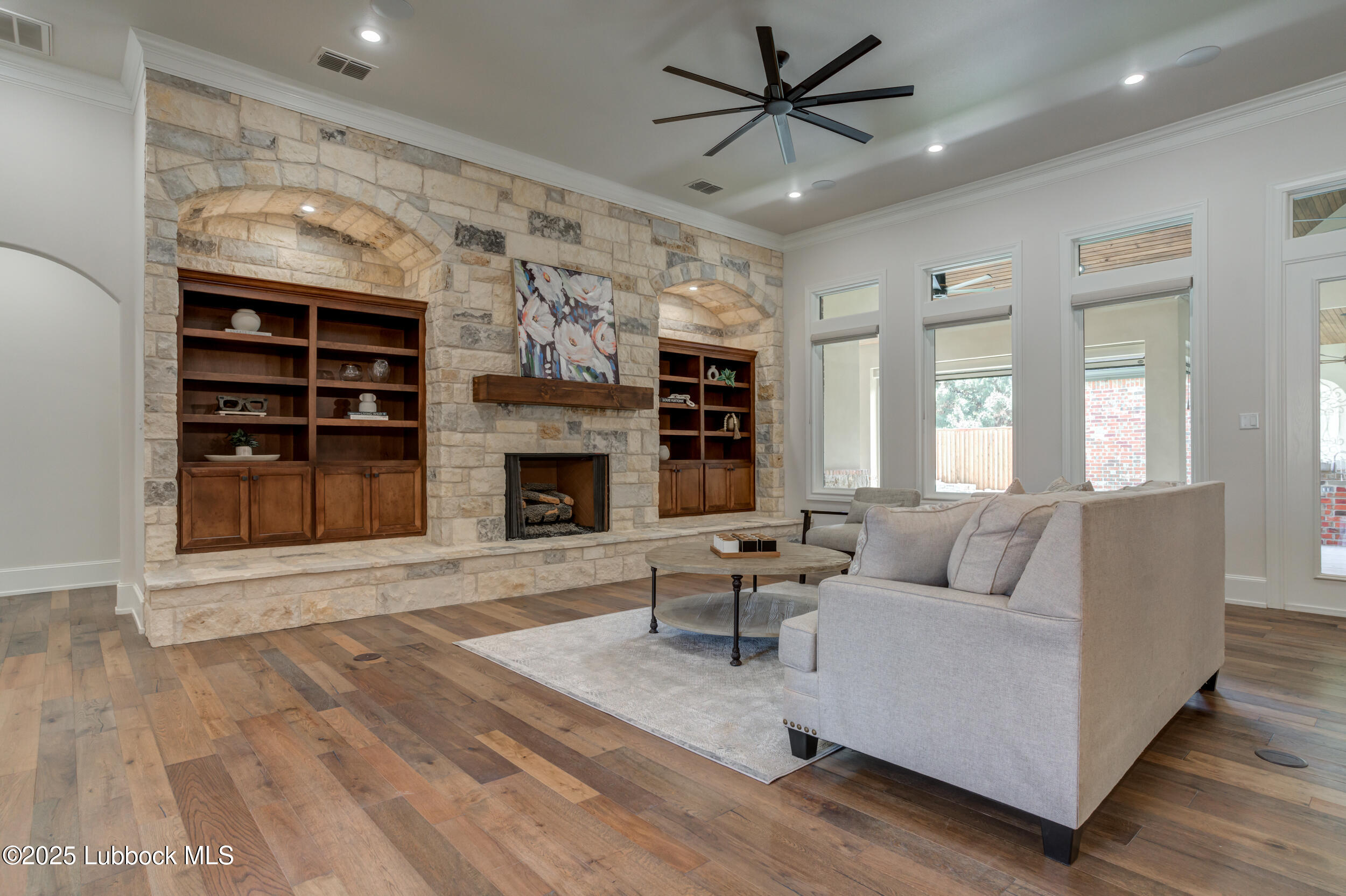 3913 106th Street Lubbock, TX 79423 - Photo 30 of 80 a living room with furniture and a fireplace