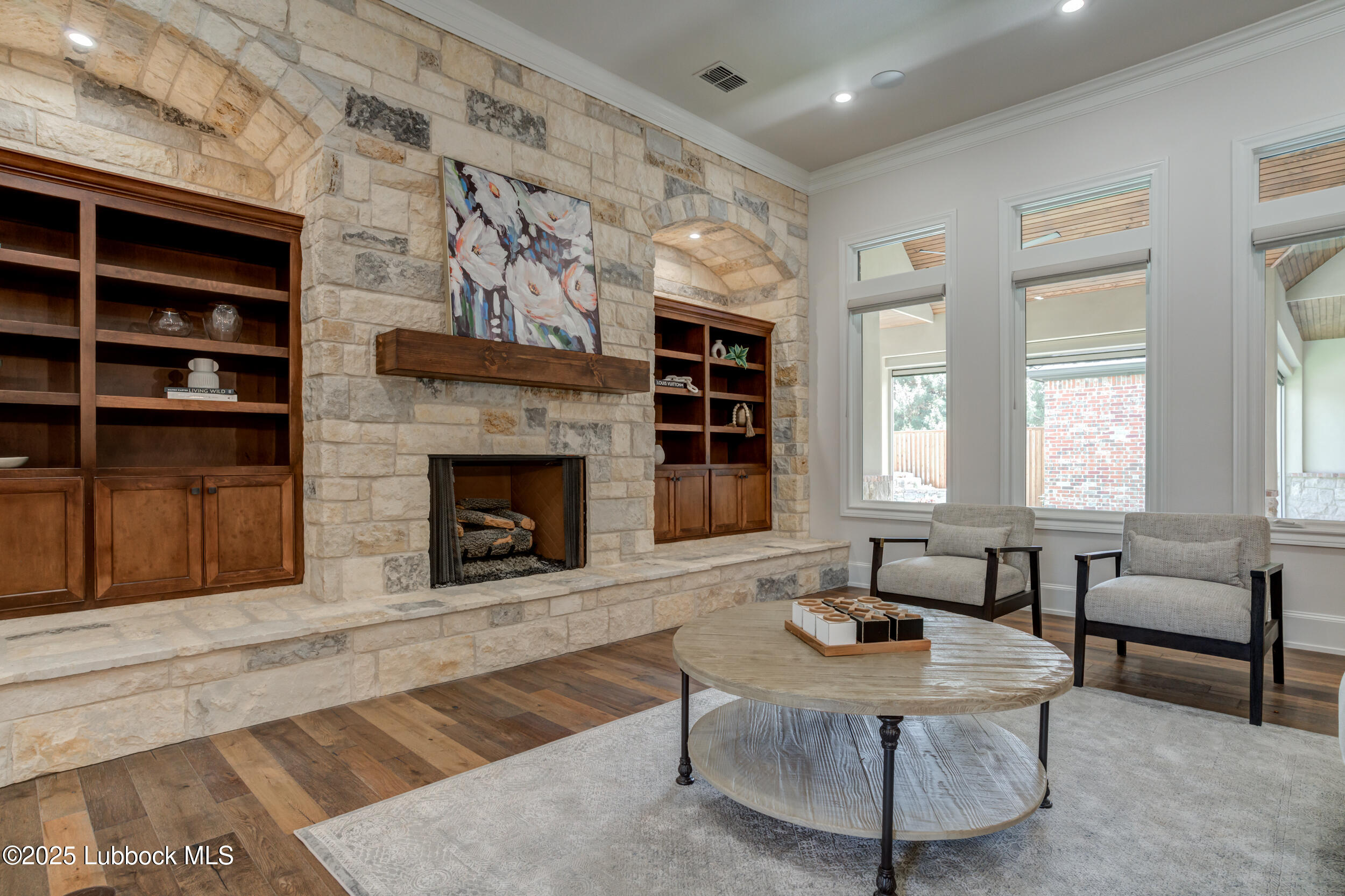 3913 106th Street Lubbock, TX 79423 - Photo 31 of 80 a living room with furniture a fireplace and a large window