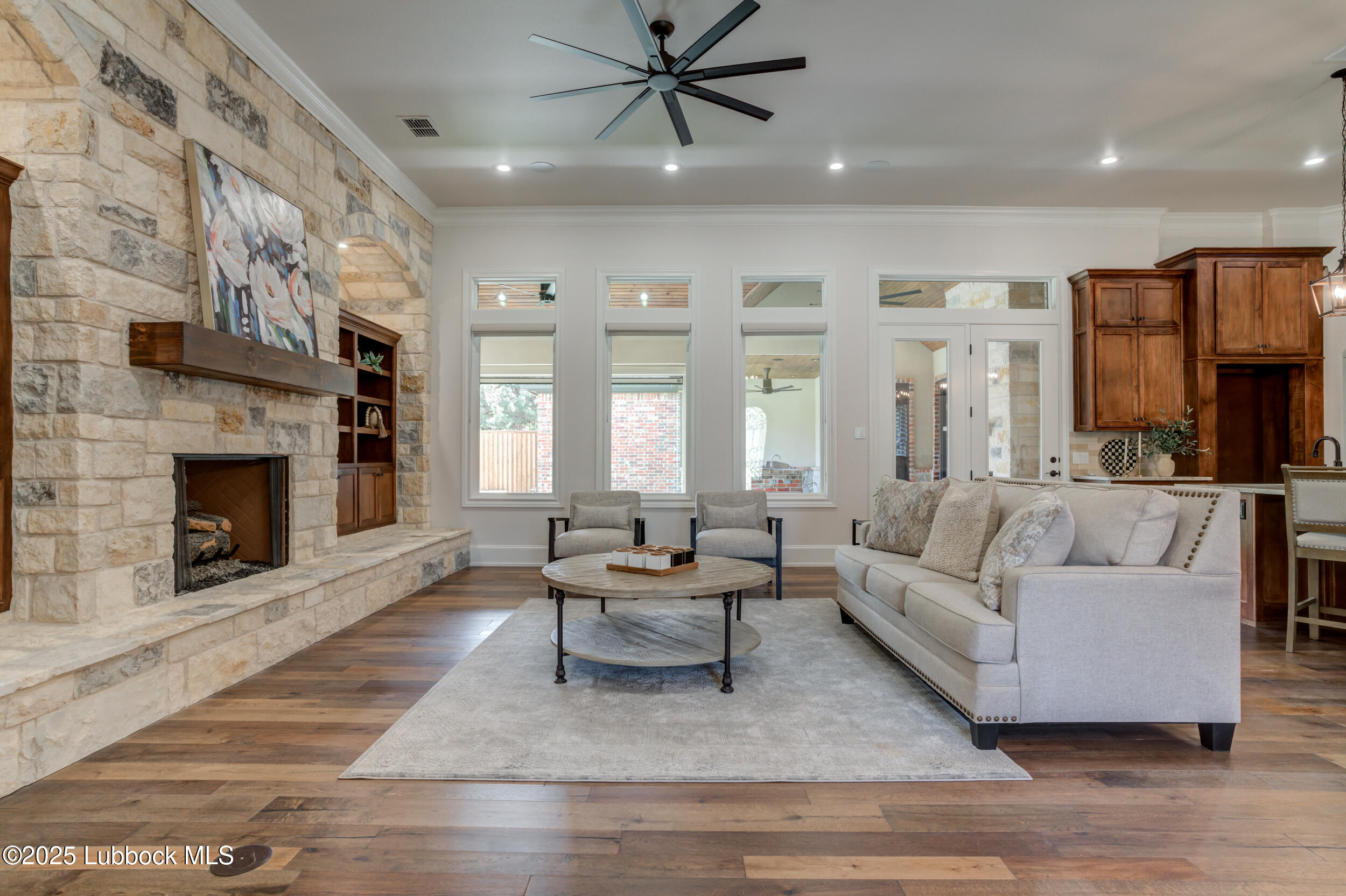 3913 106th Street Lubbock, TX 79423 - Photo 34 of 80 a living room with furniture and a fireplace