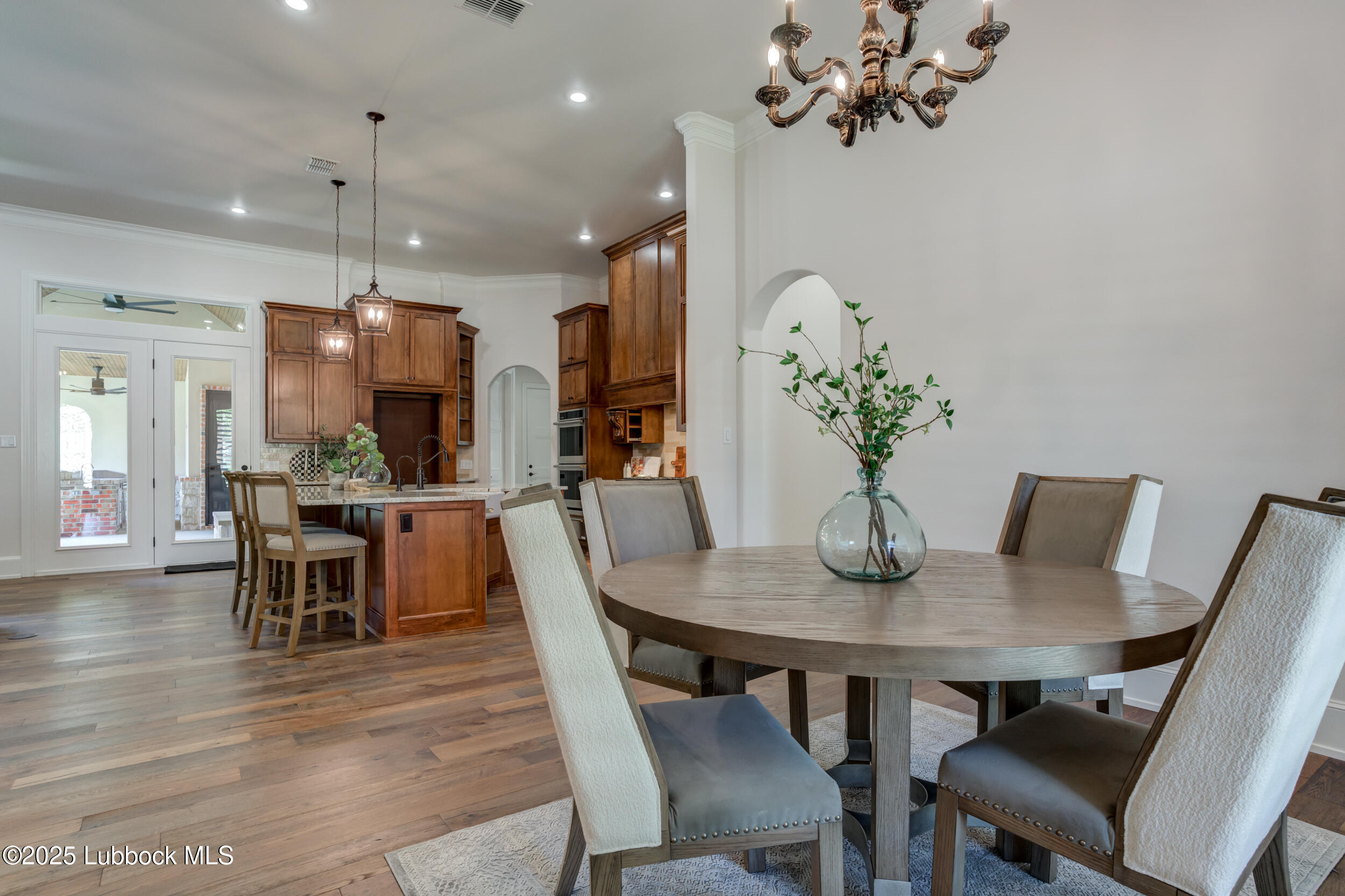3913 106th Street Lubbock, TX 79423 - Photo 36 of 80 a view of a dining room with furniture and wooden floor