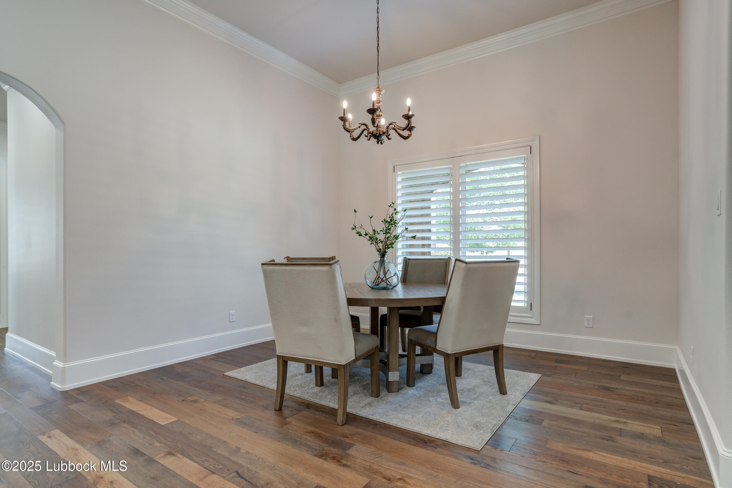 3913 106th Street Lubbock, TX 79423 - Photo 37 of 80 a view of a dining room with furniture window and wooden floor