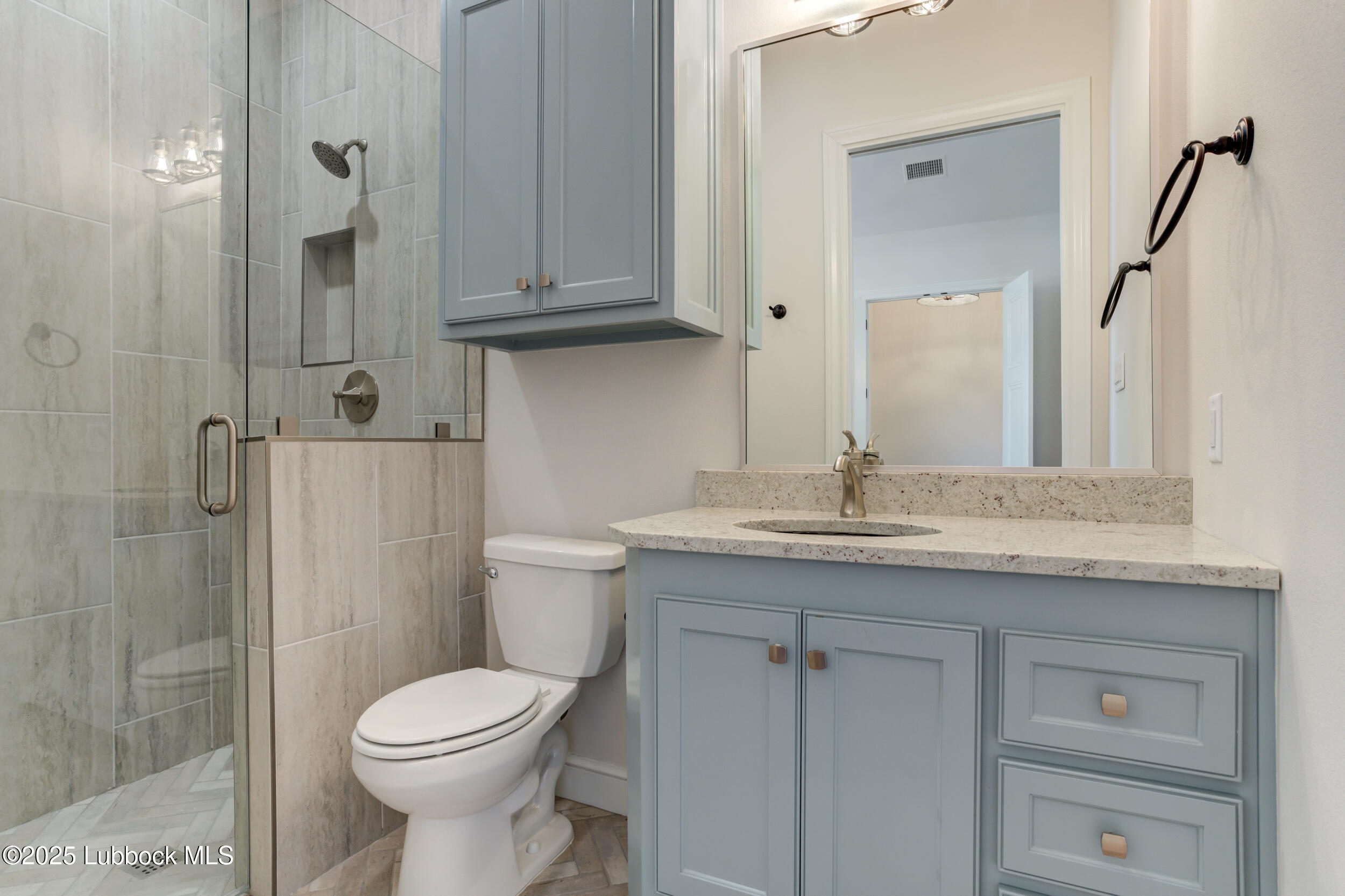 3913 106th Street Lubbock, TX 79423 - Photo 44 of 80 a bathroom with a granite countertop sink toilet and shower