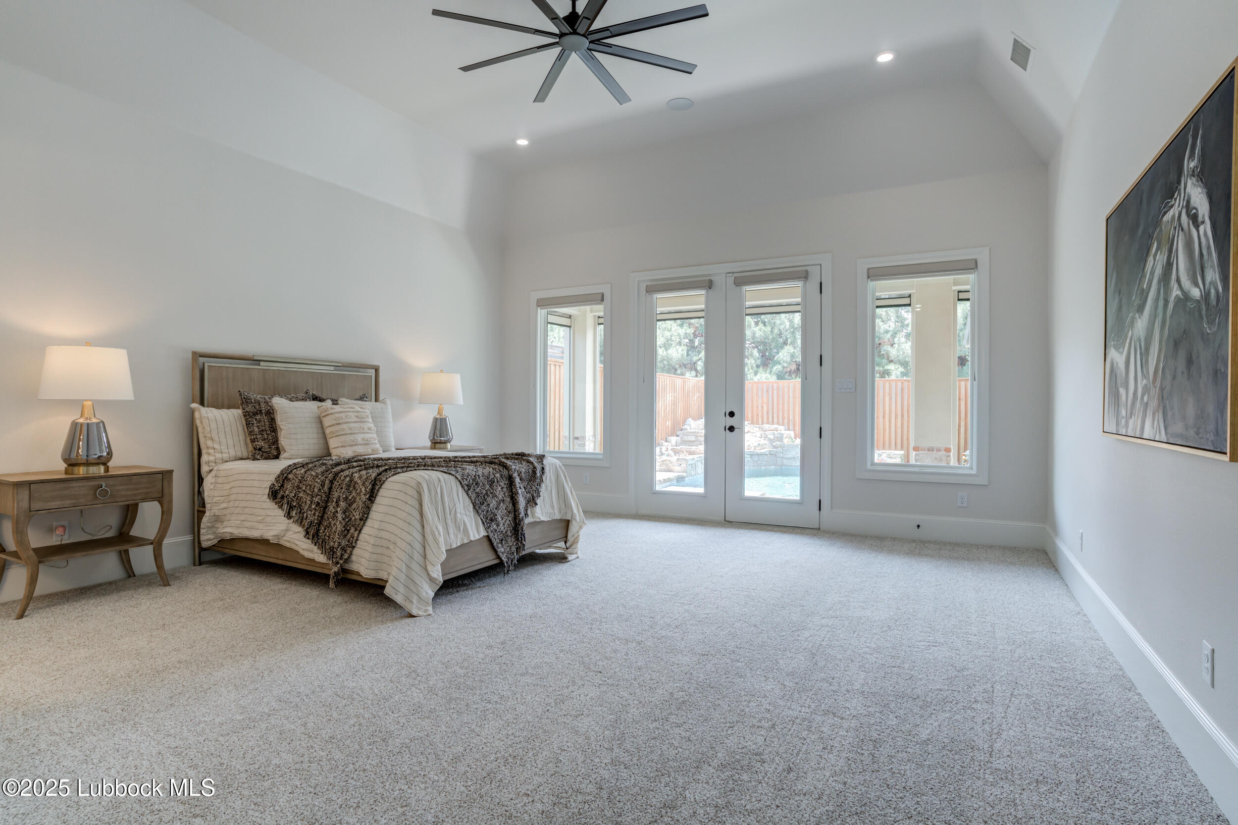 3913 106th Street Lubbock, TX 79423 - Photo 46 of 80 a spacious bedroom with a bed a couch and large window