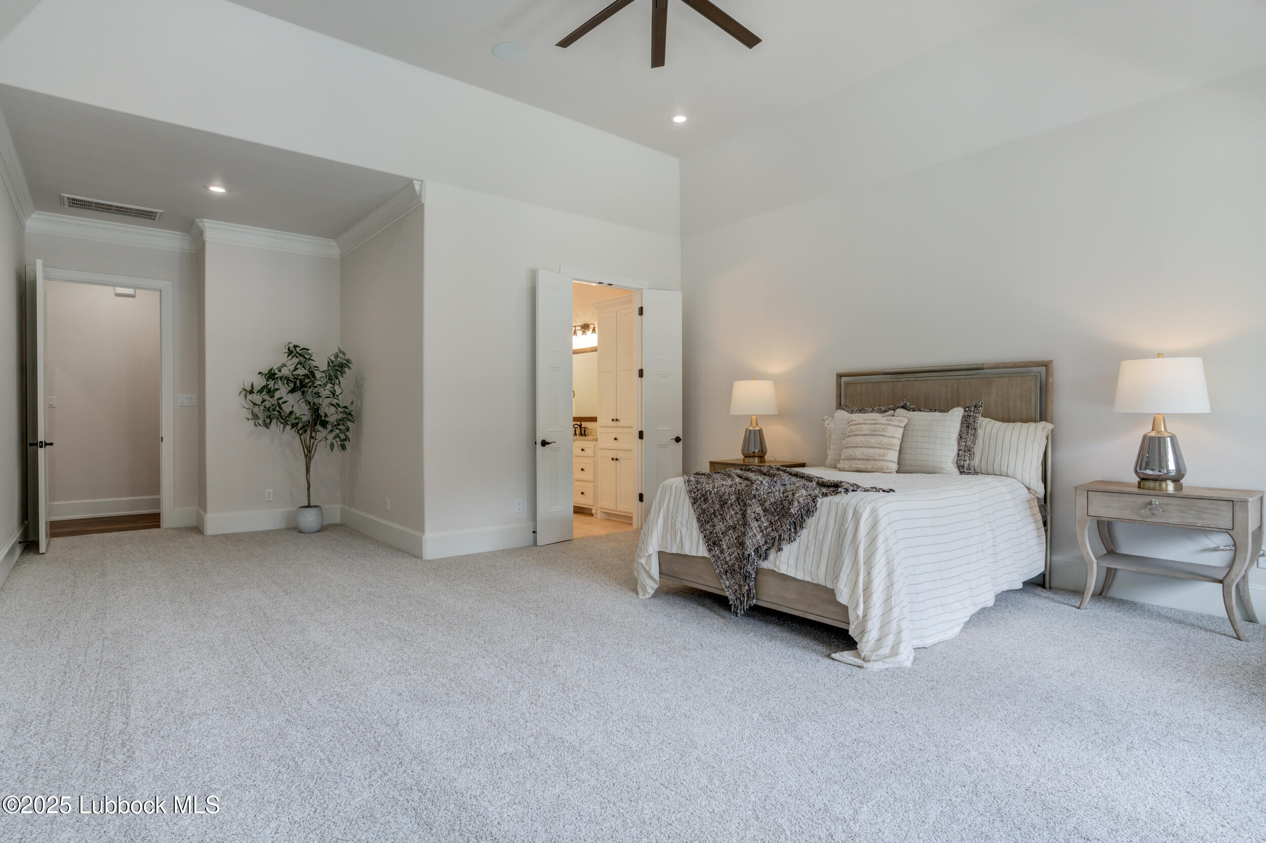 3913 106th Street Lubbock, TX 79423 - Photo 49 of 80 a spacious bedroom with a bed and a chandelier
