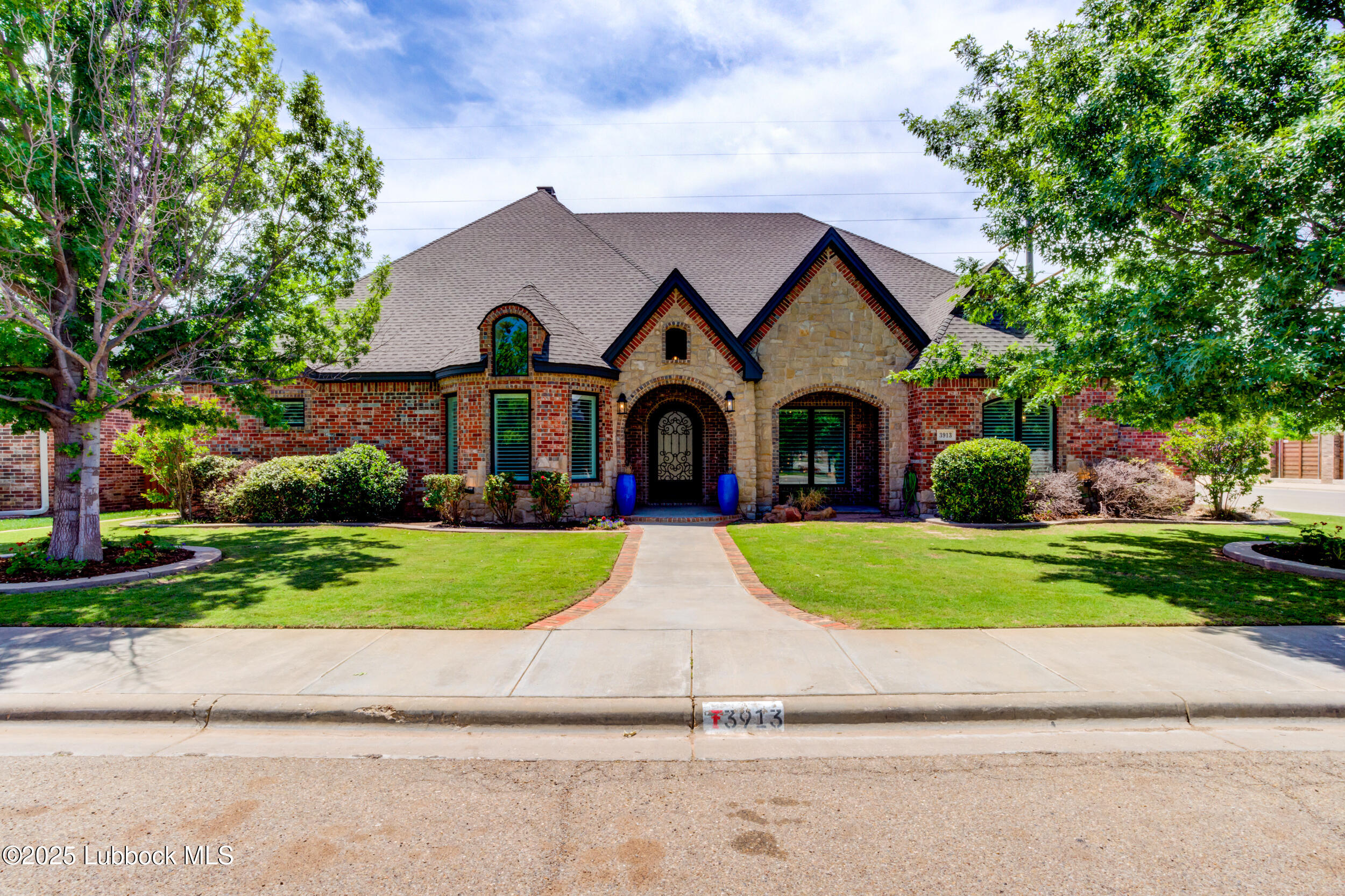 3913 106th Street Lubbock, TX 79423 - Photo 5 of 80 a front view of a house with a yard and garage