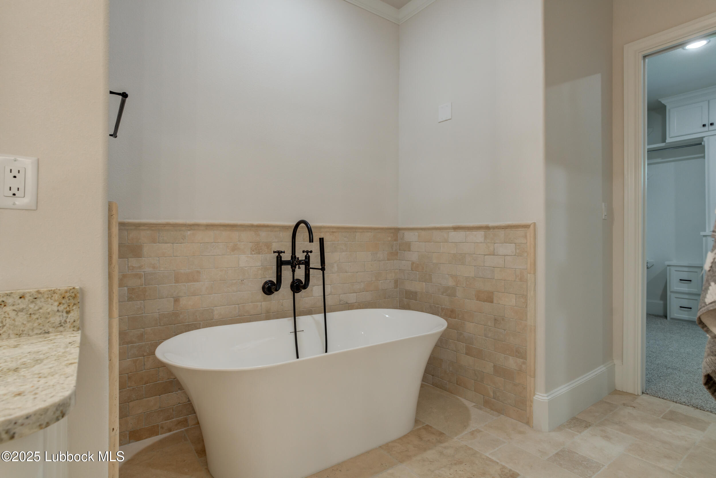 3913 106th Street Lubbock, TX 79423 - Photo 56 of 80 a white bath tub sitting in a bathroom