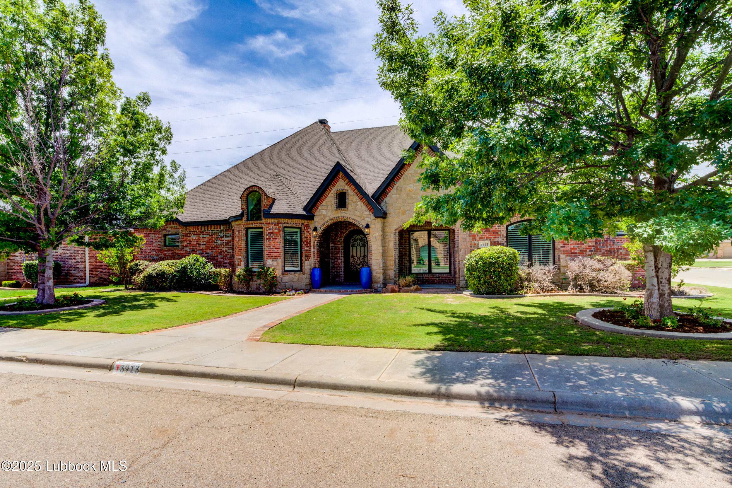 3913 106th Street Lubbock, TX 79423 - Photo 6 of 80 a front view of a house with a yard and garage