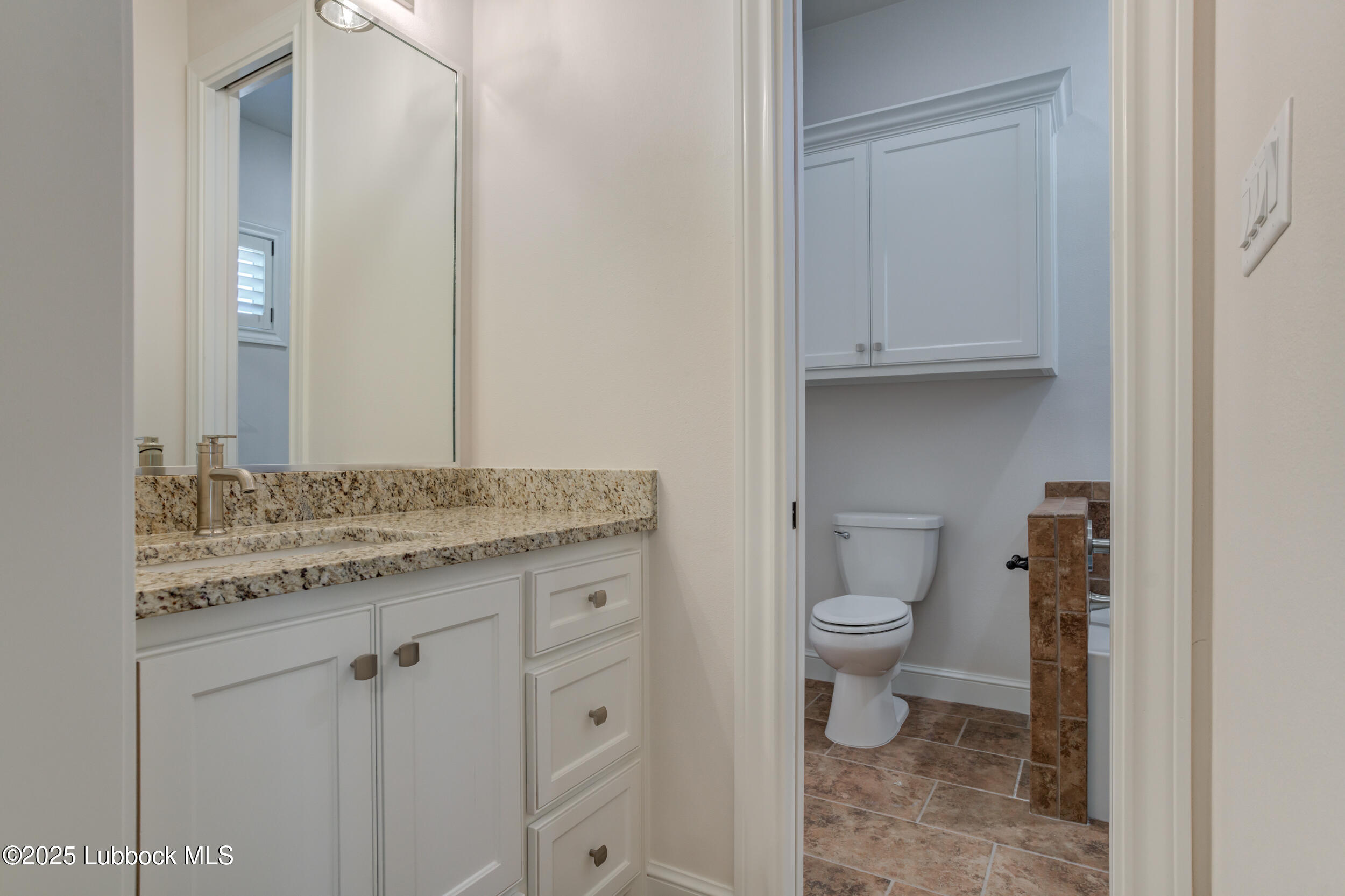 3913 106th Street Lubbock, TX 79423 - Photo 66 of 80 a bathroom with a granite countertop toilet and a sink