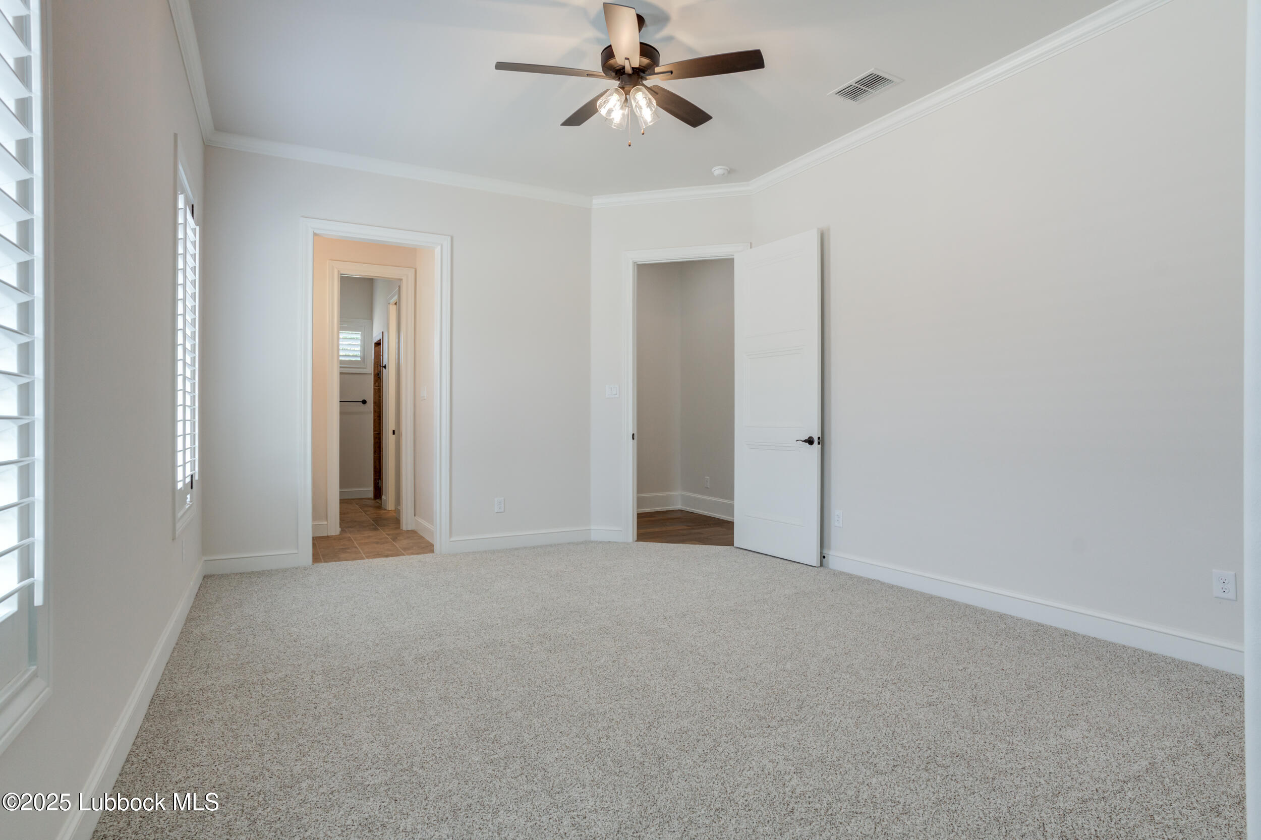 3913 106th Street Lubbock, TX 79423 - Photo 70 of 80 an empty room with closet and a ceiling fan