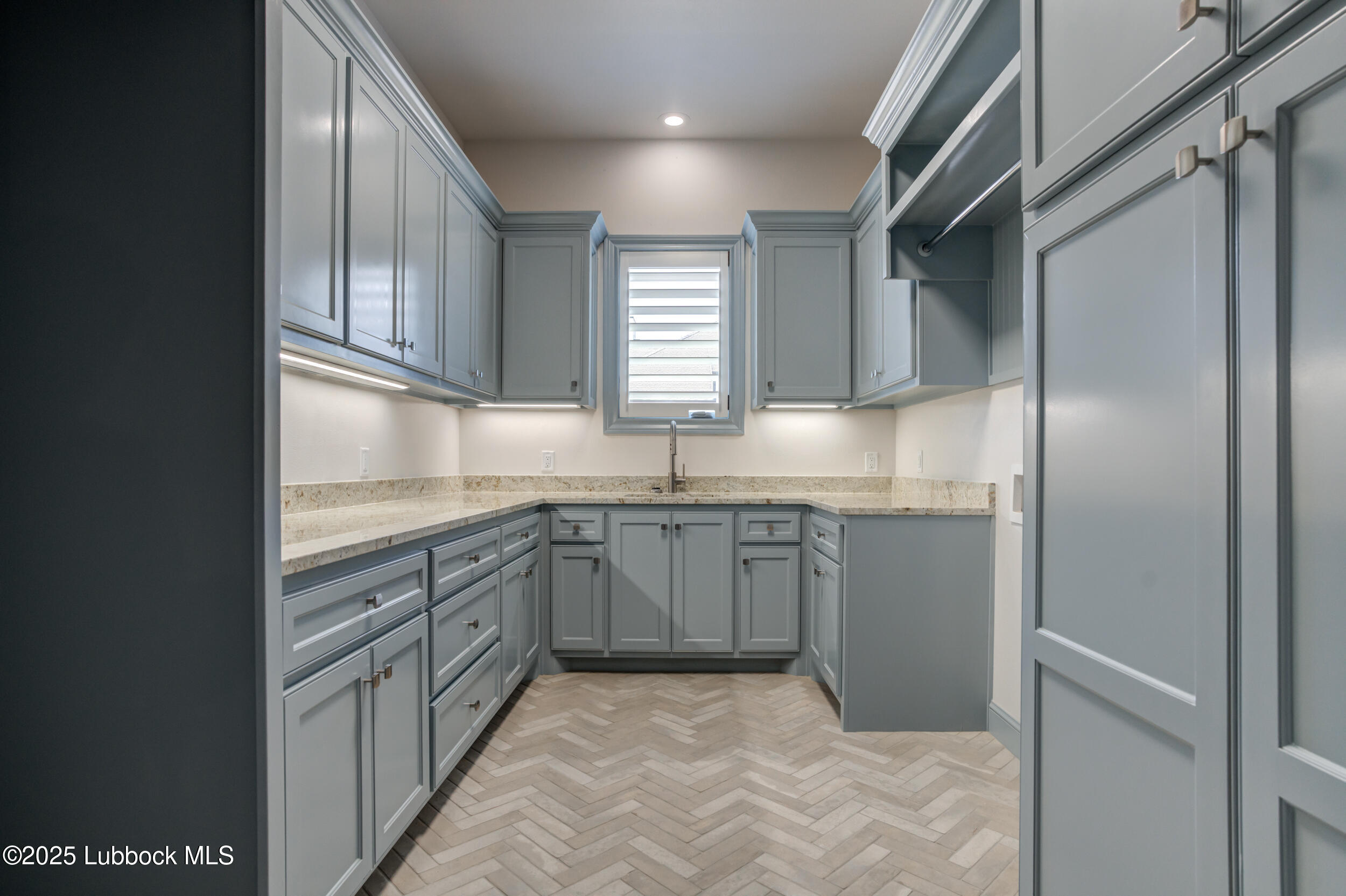 3913 106th Street Lubbock, TX 79423 - Photo 71 of 80 a kitchen with granite countertop a sink stainless steel appliances and cabinets