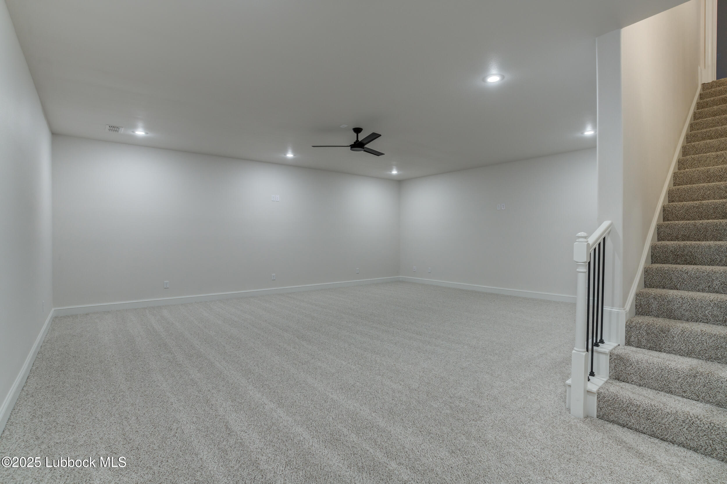 3913 106th Street Lubbock, TX 79423 - Photo 74 of 80 an empty room with a ceiling fan and windows