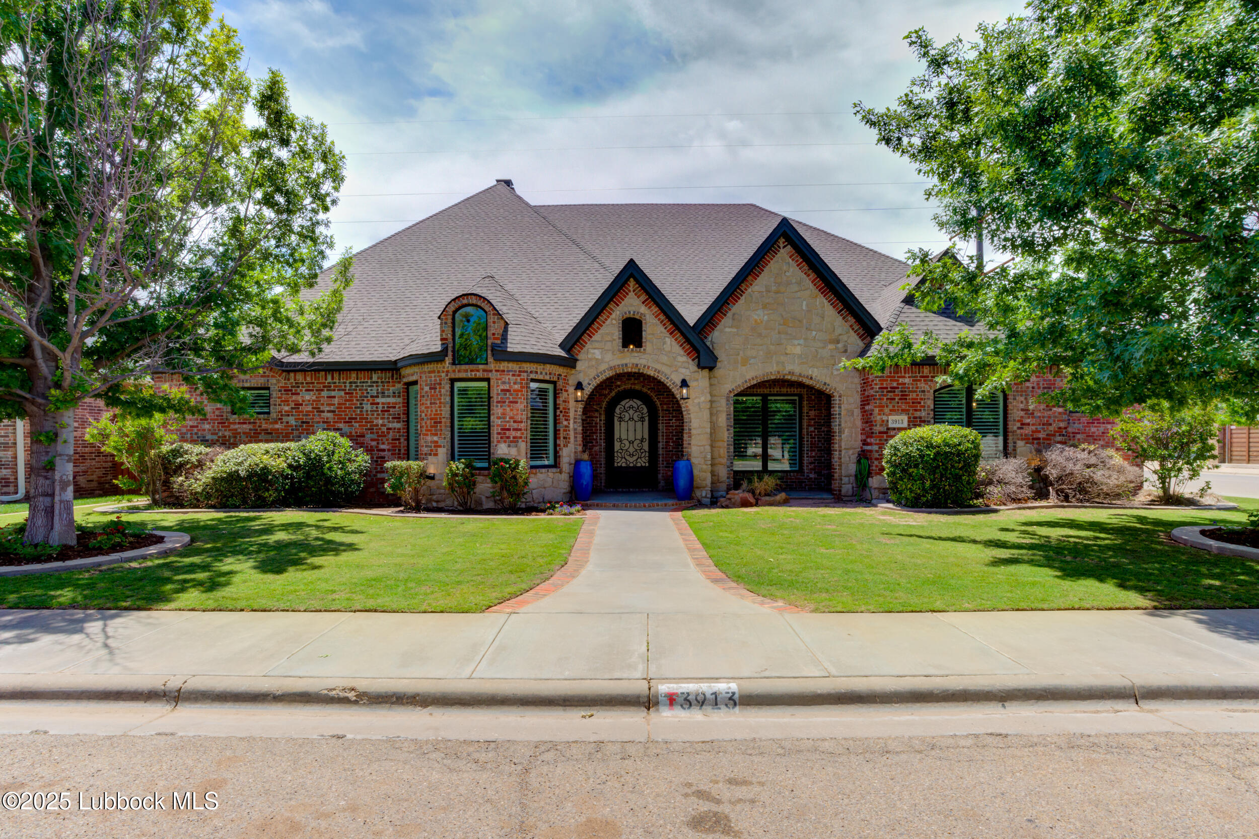 3913 106th Street Lubbock, TX 79423 - Photo 8 of 80 a front view of a house with a yard and garage