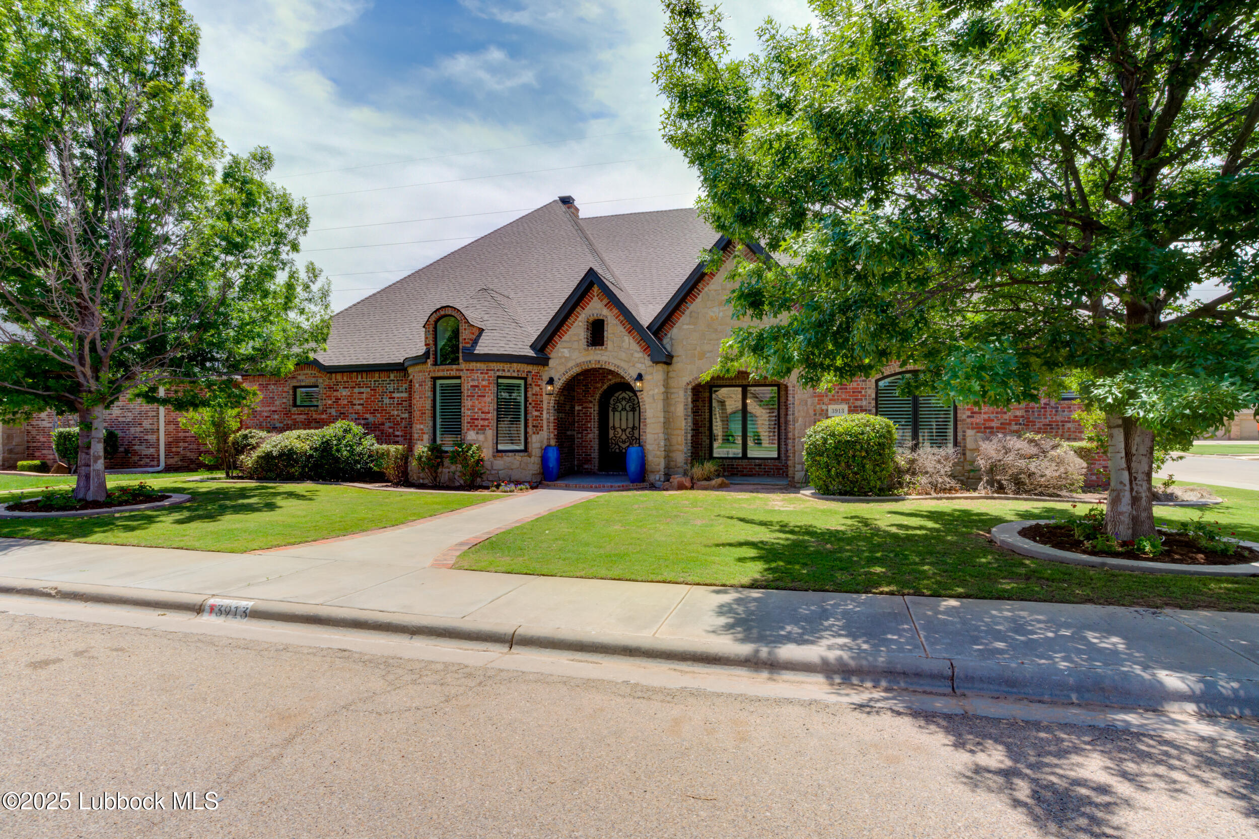 3913 106th Street Lubbock, TX 79423 - Photo 10 of 80 a front view of a house with a yard and garage