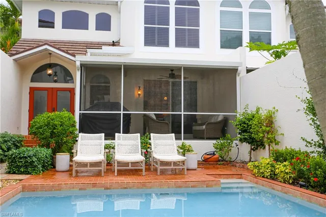 a view of a patio with table and chairs potted plants