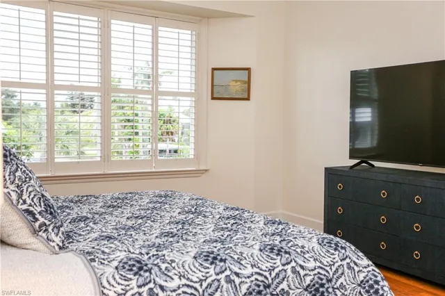 a bedroom with a bed and a television